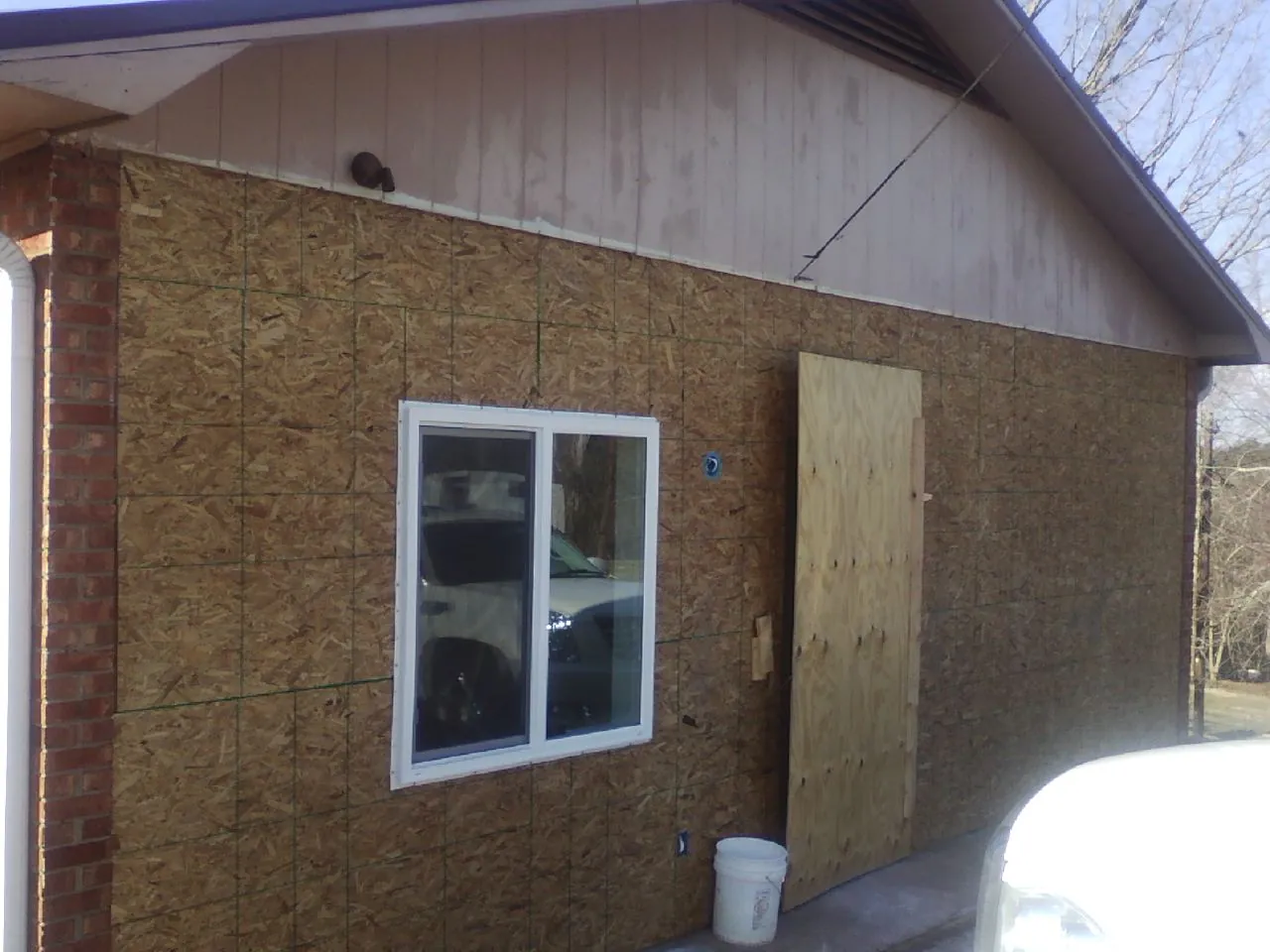OSB sheathing on a garage addition wall before siding in East Galesburg